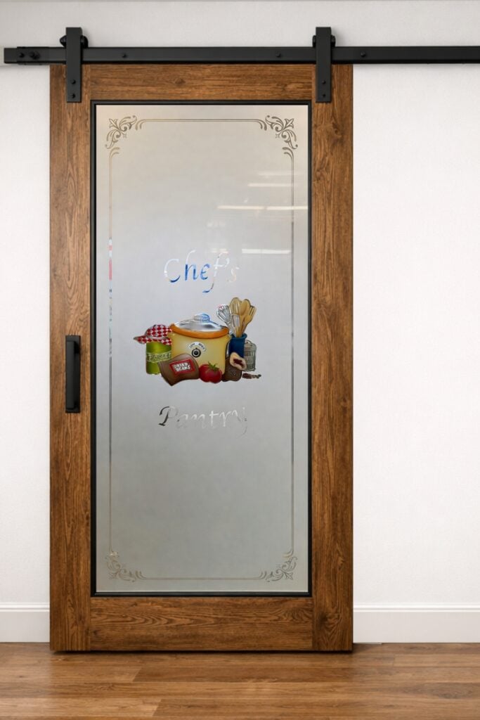 Frosted glass pantry barn door with custom chef design combining function and artistic kitchen focal point