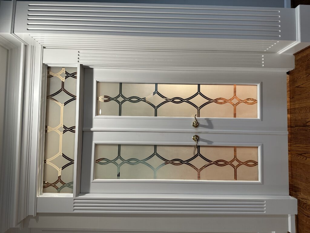 Frosted glass double interior doors with transom, Diamond Beads design in 1D negative, illuminated from behind showing brighter frosted glass and pattern detail