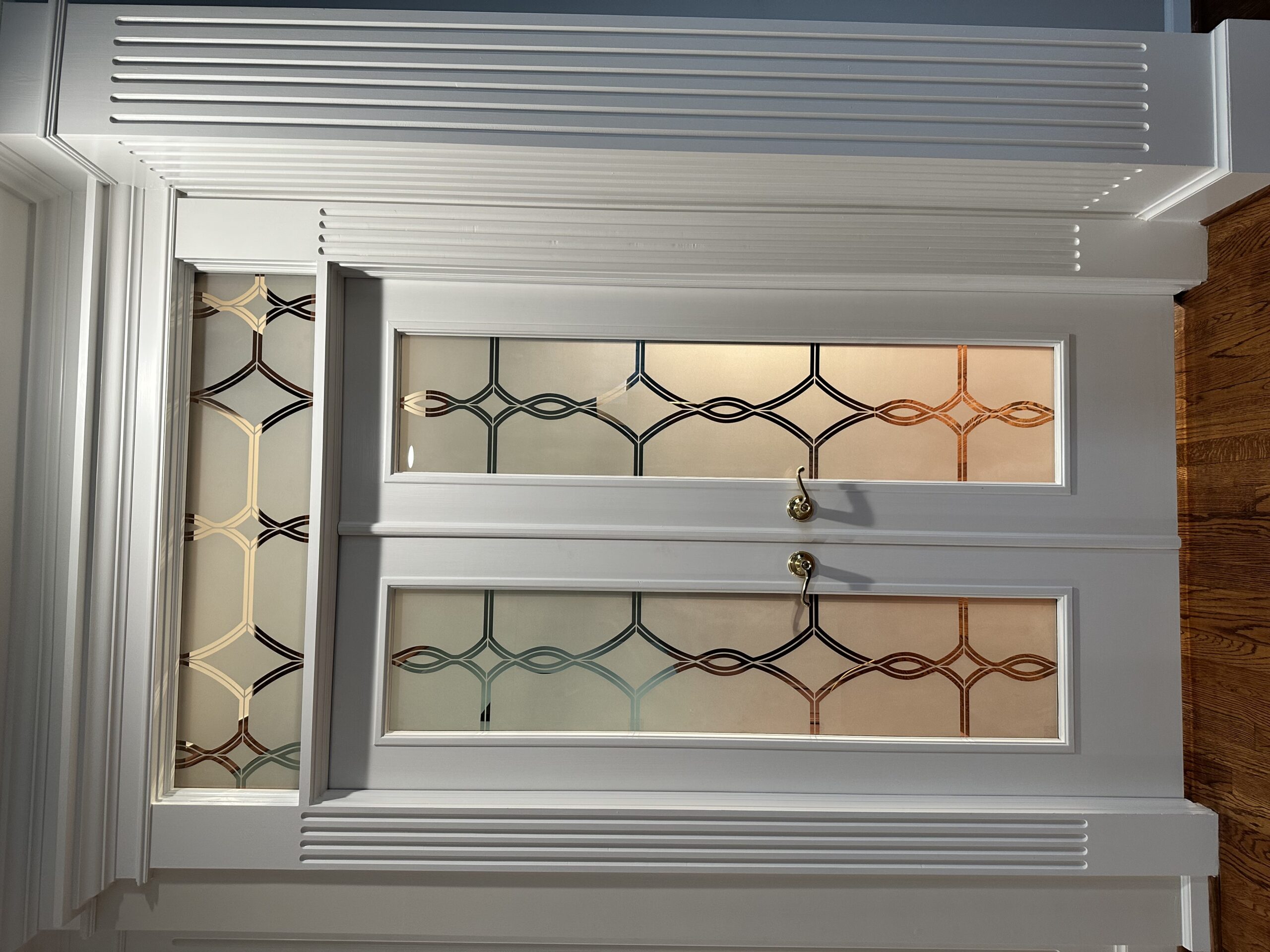 Backlit decorative glass Pair doors at night with glowing design and increased visibility through glass