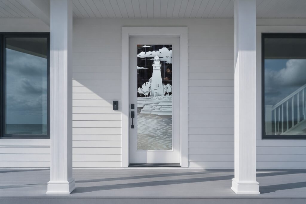 Frosted glass front door with lighthouse design on a clean modern beach house porch