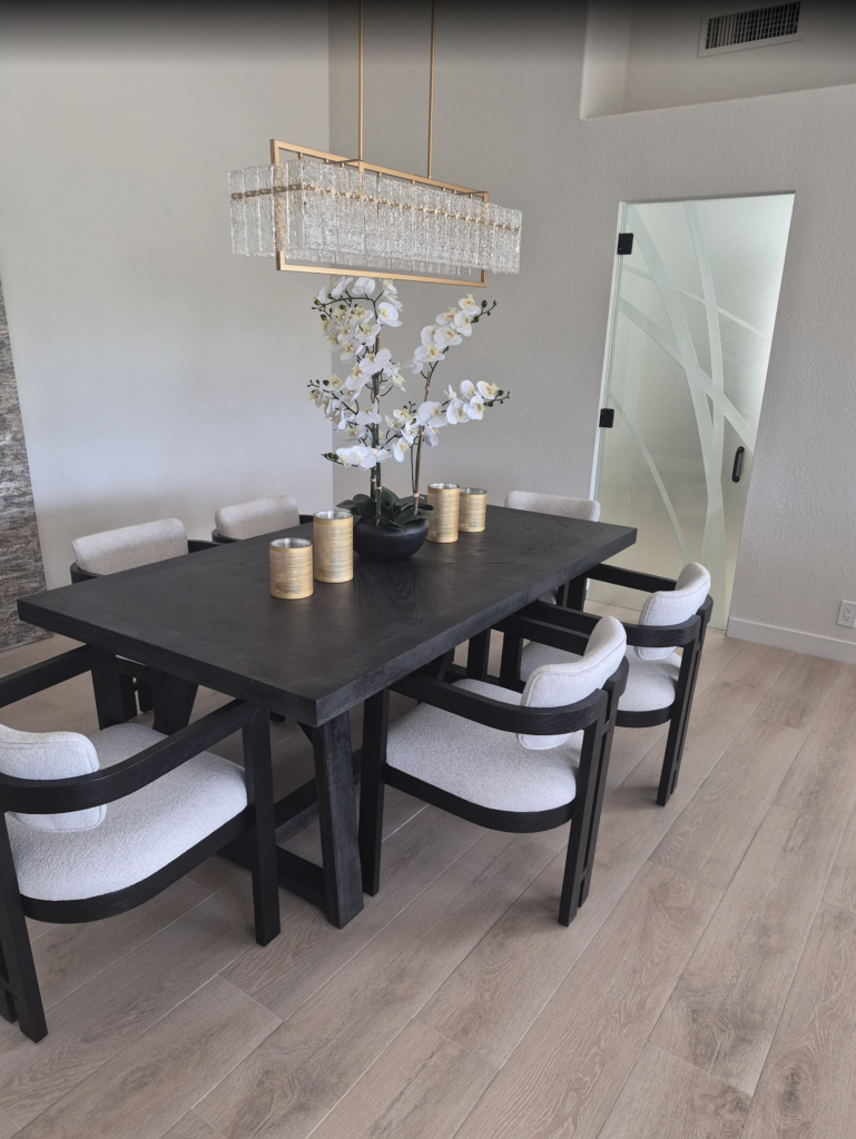 Interior frosted glass door with abstract carved lines used as a kitchen partition near a modern dining area, adding privacy while keeping the space bright.