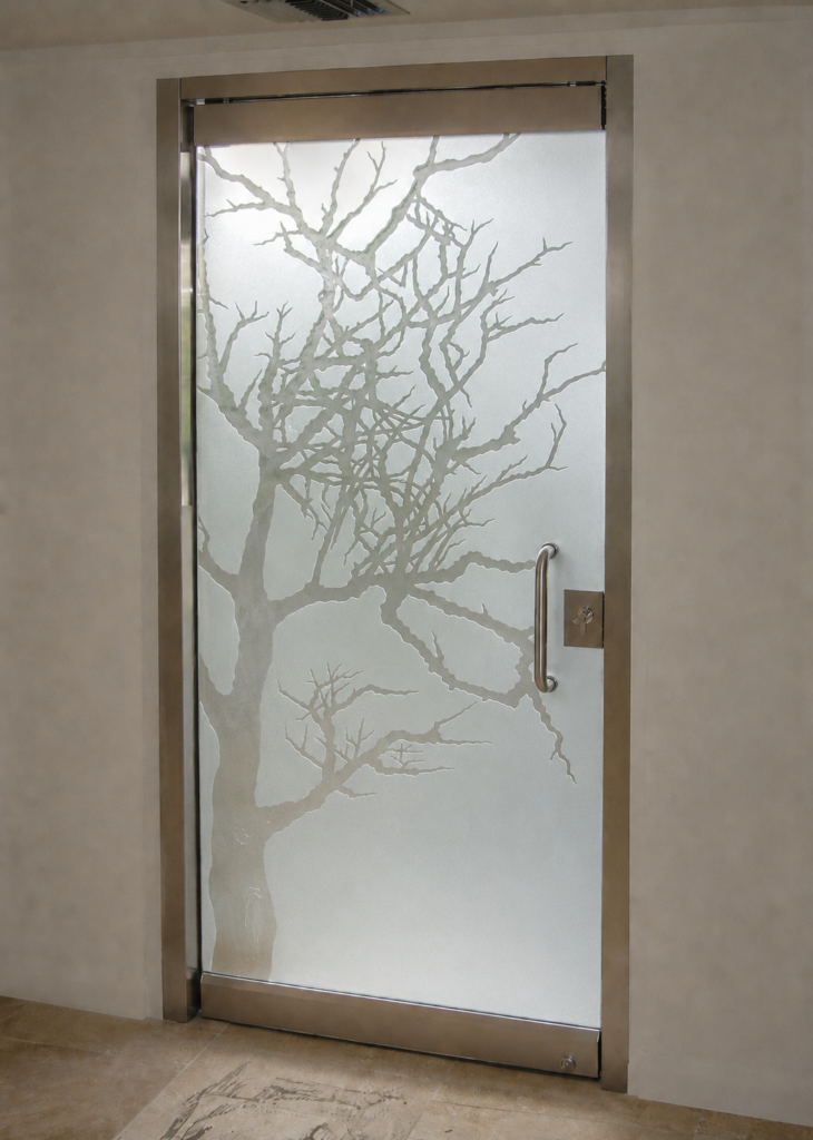 Glass front door with dramatic tree design for privacy